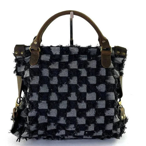 Handcrafted checkered tote bag with frayed texture and leather handles, luxury designer accessory