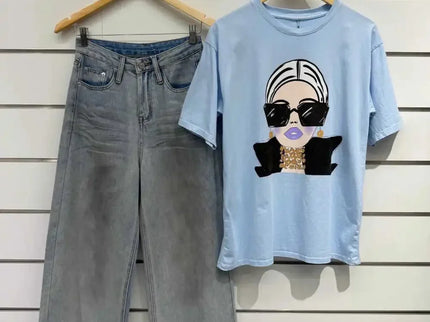 Light blue graphic tee with stylish woman print paired with wide-leg denim jeans, modern casual outfit