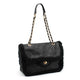Luxury black quilted handbag with shearling trim and gold chain strap, designer fashion accessory