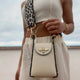 Cream leather crossbody bag with gold bee clasp and leopard strap, styled with chic summer outfit