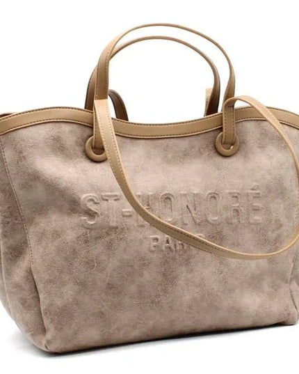 Beige suede tote bag with embossed logo, dual top handles, and shoulder strap for everyday luxury style.