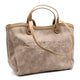 Beige suede tote bag with embossed logo, dual top handles, and shoulder strap for everyday luxury style.