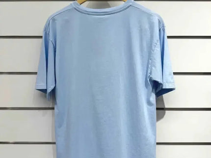 Light blue oversized t-shirt on wooden hanger, minimalist design for casual luxury style