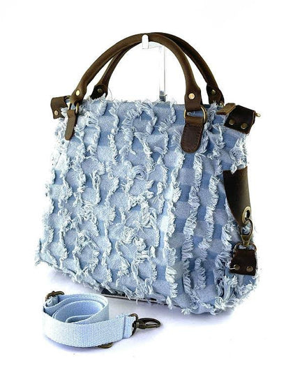 Light blue frayed denim tote bag with brown leather handles and detachable strap, luxury designer accessory