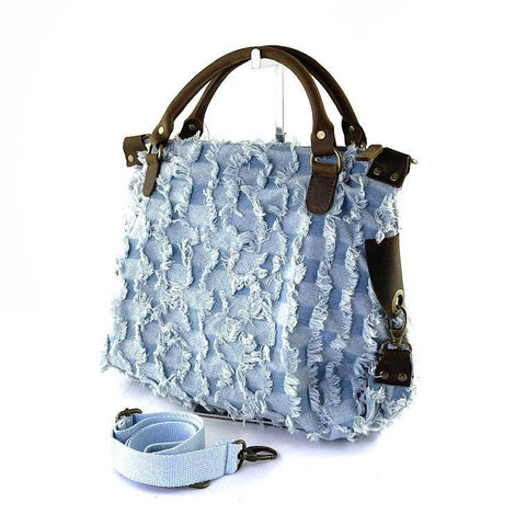 Light blue frayed denim tote bag with brown leather handles and detachable strap, luxury designer accessory