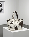 Printed bag with cow pattern and long, soft handles 