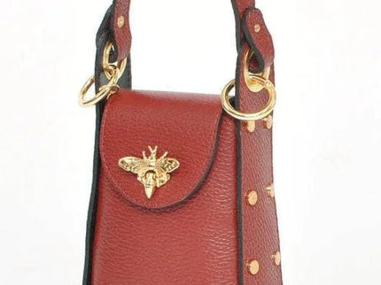 Luxury red leather handbag with gold bee clasp and studded details, designer accessory for unique style