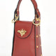 Luxury red leather handbag with gold bee clasp and studded details, designer accessory for unique style
