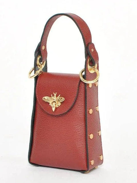 Luxury red leather handbag with gold bee clasp and studded details, designer accessory for unique style