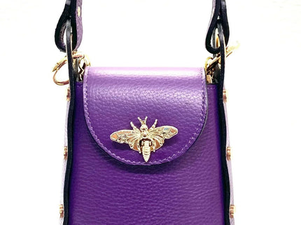 Purple leather handbag with gold bee clasp, black trim, and top handle. Luxury designer accessory.