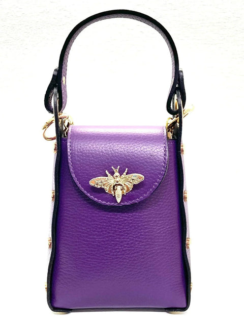 Purple leather handbag with gold bee clasp, black trim, and top handle. Luxury designer accessory.