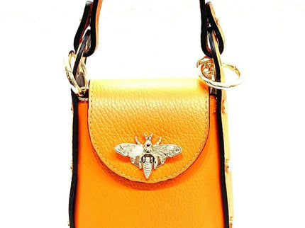 Vibrant orange leather handbag with gold bee clasp and black trim, luxury designer accessory