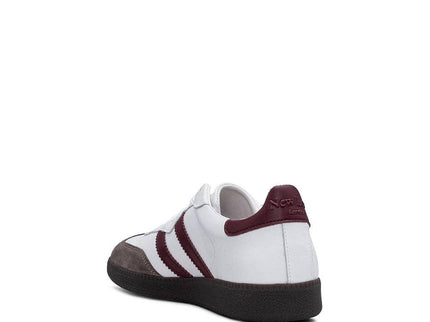 White and burgundy retro sneaker with three stripes, leather upper, and gum sole