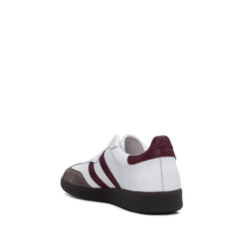 White and burgundy retro sneaker with three stripes, leather upper, and gum sole